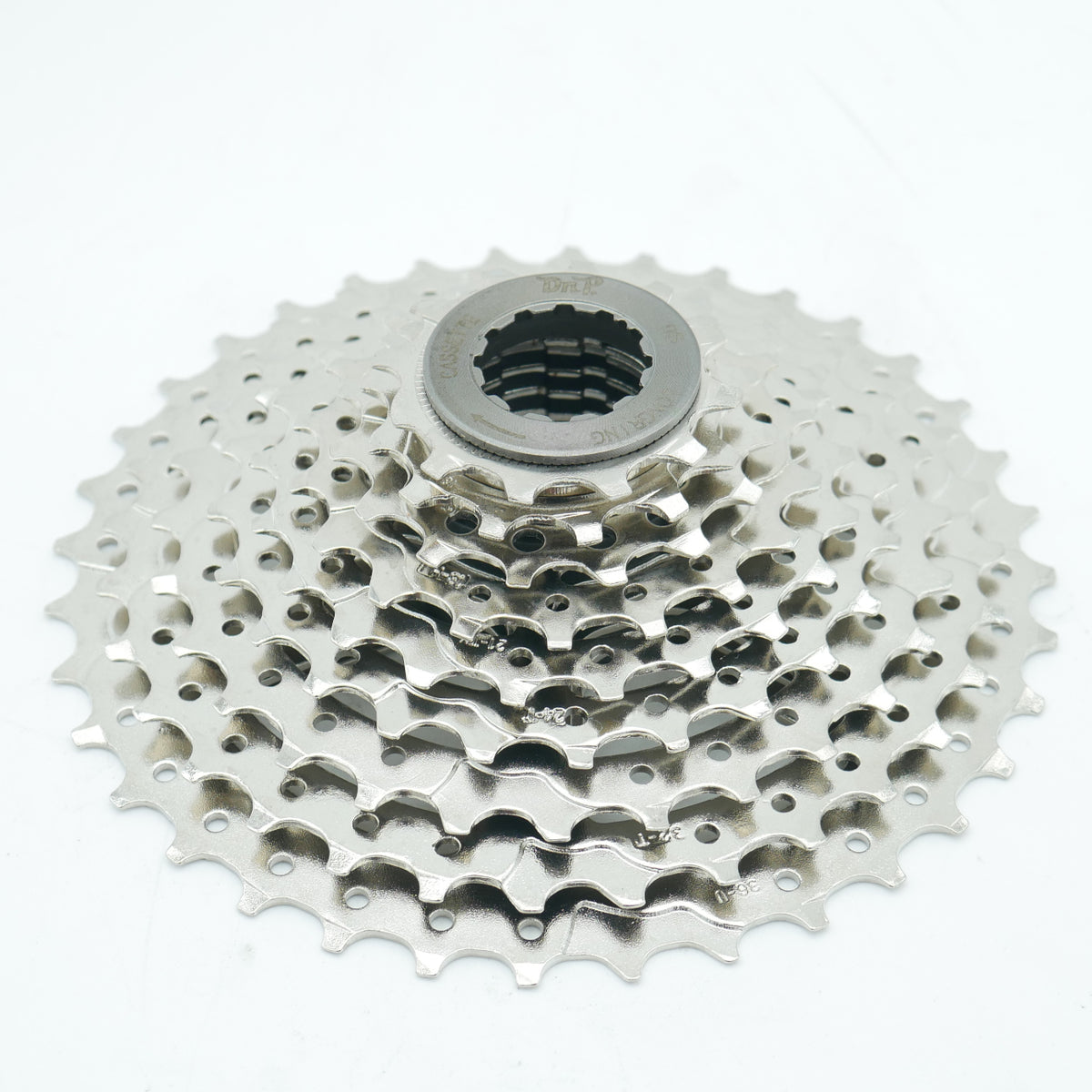 A silver DNP 9-speed cassette for bicycles, displayed on a white background.